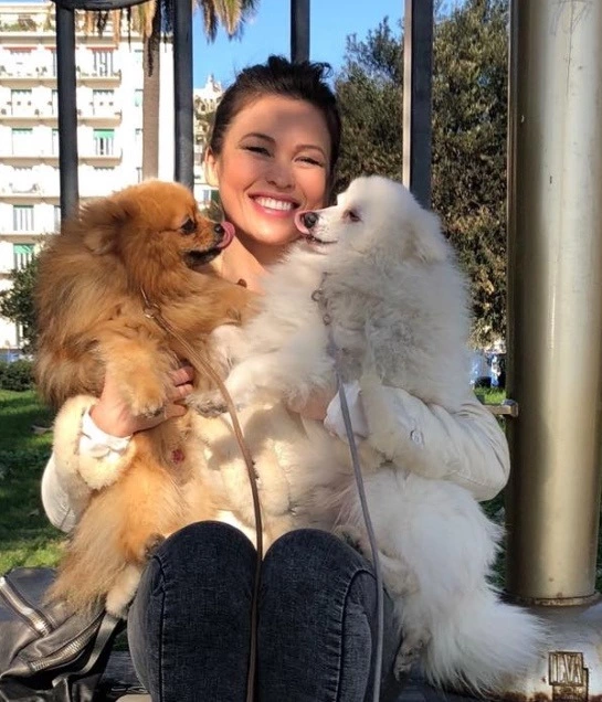 Yulia Mayarchuk with two dogs on the street
